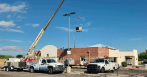 Commercial Heating & Cooling project with trucks and crane image